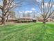 Well-maintained single-story brick home with a manicured front lawn and mature trees at 9406 Northeastern Ave, Indianapolis, IN 46239
