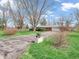 Inviting single-story brick home features a long driveway and a lush green lawn at 9406 Northeastern Ave, Indianapolis, IN 46239