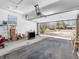 Spacious open garage with overhead door, TV, and yard view at 9406 Northeastern Ave, Indianapolis, IN 46239
