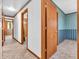 A hallway in a home with doors leading to multiple rooms at 9406 Northeastern Ave, Indianapolis, IN 46239