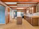 Well-lit kitchen area features wooden cabinets, tile countertops, and a functional island at 9406 Northeastern Ave, Indianapolis, IN 46239