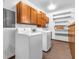 Functional laundry area with appliances, storage cabinets, and shelving at 9406 Northeastern Ave, Indianapolis, IN 46239