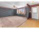 Spacious living room features carpet, decorative wallpaper, and lots of natural light at 9406 Northeastern Ave, Indianapolis, IN 46239