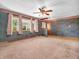 Cozy living room with neutral carpet and large windows, perfect for relaxation at 9406 Northeastern Ave, Indianapolis, IN 46239