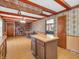Open concept living room with brick fireplace and an island bar at 9406 Northeastern Ave, Indianapolis, IN 46239
