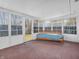 A sunroom featuring a futon and floor to ceiling windows with a view at 9406 Northeastern Ave, Indianapolis, IN 46239