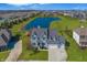 Beautiful aerial view of the home with a pond, lush green lawn, and a view of the neighborhood at 1043 Palomar Dr, Westfield, IN 46074