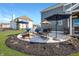 A back patio featuring a seating area with lounge furniture, a dining table, and an umbrella at 1043 Palomar Dr, Westfield, IN 46074