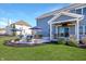 Outdoor back patio with a dining table, lounge furniture, and a shaded seating area at 1043 Palomar Dr, Westfield, IN 46074