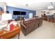 Basement living area with a large leather sofa, mounted televisions, a bar area, and comfortable seating at 1043 Palomar Dr, Westfield, IN 46074