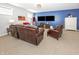 Basement living area with a blue accent wall, television, a comfortable leather sofa, and a cozy chair at 1043 Palomar Dr, Westfield, IN 46074