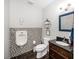 Unique half bath with stylish fixtures, a mosaic tile accent wall, and dark wood vanity at 1043 Palomar Dr, Westfield, IN 46074