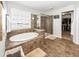 Spacious bathroom featuring a separate tub, glass shower, and lots of natural light at 1043 Palomar Dr, Westfield, IN 46074