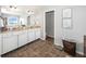 Large bathroom with double sinks, white cabinets, and tile floors at 1043 Palomar Dr, Westfield, IN 46074