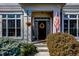 Charming front porch with a welcoming wreath, hanging flower basket, and an American flag at 1043 Palomar Dr, Westfield, IN 46074