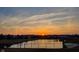 Sunset view of a community with a lake and trees silhouetted against a bright sky at 1043 Palomar Dr, Westfield, IN 46074