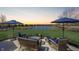 Inviting outdoor patio with comfortable seating, a fire pit, and a scenic view of the pond at 1043 Palomar Dr, Westfield, IN 46074
