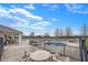 Community pool area with lounge chairs, tables, and a hot tub surrounded by a black iron fence and patio at 1043 Palomar Dr, Westfield, IN 46074