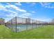 Community tennis courts enclosed by a black chain-link fence, surrounded by green lawns and trees at 1043 Palomar Dr, Westfield, IN 46074