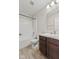 Cozy bathroom features a shower-tub combo, wood look floors, granite vanity, and a well-lit mirror at 10522 Hunters Crossing Blvd, Indianapolis, IN 46239