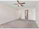 Large bedroom with carpeting, ceiling fan, and an adjacent closet at 10522 Hunters Crossing Blvd, Indianapolis, IN 46239