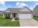 Charming single-story home with attached two-car garage and well-manicured front lawn at 10522 Hunters Crossing Blvd, Indianapolis, IN 46239