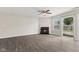 Spacious living room with fireplace, light-colored walls, and sliding glass door to the outside at 10522 Hunters Crossing Blvd, Indianapolis, IN 46239