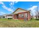 Brick home with covered patio and green lawn backing up to other single Gathering homes at 10629 Medinah Dr # 1, Indianapolis, IN 46234