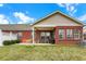 Brick home with covered patio, green lawn, and bright outdoor seating for relaxing at 10629 Medinah Dr # 1, Indianapolis, IN 46234