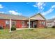 Brick home with covered patio, green lawn, and bright blue sky with puffy clouds at 10629 Medinah Dr # 1, Indianapolis, IN 46234