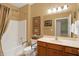 Well-lit bathroom with a vanity, framed mirror, and tub-shower combination with safety bars at 10629 Medinah Dr # 1, Indianapolis, IN 46234