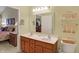 Bathroom featuring a double sink vanity, framed mirror, and adjacent view into the main bedroom at 10629 Medinah Dr # 1, Indianapolis, IN 46234