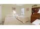 Charming bedroom featuring twin beds, a desk, and a window, creating a warm and inviting space at 10629 Medinah Dr # 1, Indianapolis, IN 46234