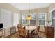 Cozy dining area featuring natural light from several windows and a decorative pendant light fixture at 10629 Medinah Dr # 1, Indianapolis, IN 46234