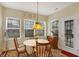 Cozy dining area featuring a round table, a chandelier, and natural lighting at 10629 Medinah Dr # 1, Indianapolis, IN 46234