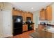 Bright kitchen with black appliances, hardwood floors, and stylish decor at 10629 Medinah Dr # 1, Indianapolis, IN 46234