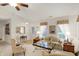 Bright living room with neutral tones, featuring a ceiling fan, and two large windows at 10629 Medinah Dr # 1, Indianapolis, IN 46234