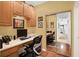 Functional home office with a built-in desk, cabinets, and closet with mirrored sliding doors at 10629 Medinah Dr # 1, Indianapolis, IN 46234