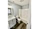 An updated bathroom with a gray vanity, tub and shower combo, and wood look flooring at 1100 Graham St, Franklin, IN 46131