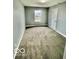 A gray bedroom with wall to wall carpeting and a window at 1100 Graham St, Franklin, IN 46131