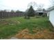 Spacious backyard with mature trees, a picnic table, and well-maintained lawn at 1106 N Hartman Dr, Indianapolis, IN 46219