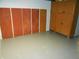 Basement storage area with storage closets and painted floor at 1106 N Hartman Dr, Indianapolis, IN 46219