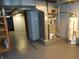 Basement utility area featuring a furnace and water heater with painted floors and block walls at 1106 N Hartman Dr, Indianapolis, IN 46219