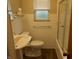 Bathroom featuring a white sink, toilet, shower and bath with window and towel rack at 1106 N Hartman Dr, Indianapolis, IN 46219