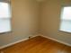 Bedroom with hardwood floors and two windows with blinds at 1106 N Hartman Dr, Indianapolis, IN 46219