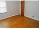 Bedroom featuring hardwood floors, neutral walls, and a window for natural light at 1106 N Hartman Dr, Indianapolis, IN 46219