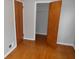 Bedroom with hardwood floors, closet, and neutral paint at 1106 N Hartman Dr, Indianapolis, IN 46219