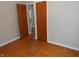Bedroom featuring hardwood floors, a window, and a door at 1106 N Hartman Dr, Indianapolis, IN 46219