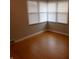 Bedroom with wood floors and a large window with blinds at 1106 N Hartman Dr, Indianapolis, IN 46219