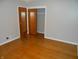 Bedroom with hardwood floors and a closet with double doors at 1106 N Hartman Dr, Indianapolis, IN 46219